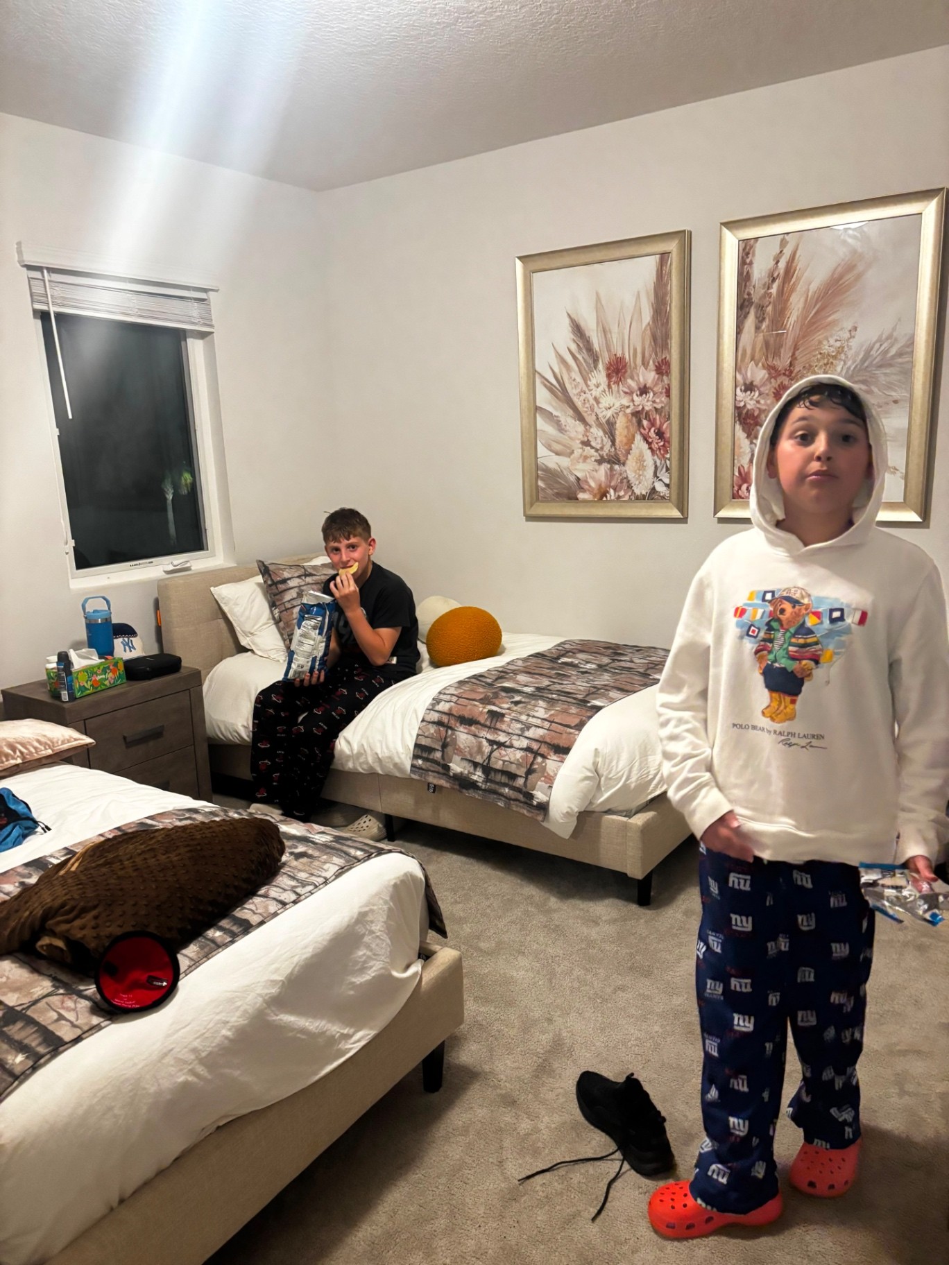 Two campers relaxing in pajamas in their room
