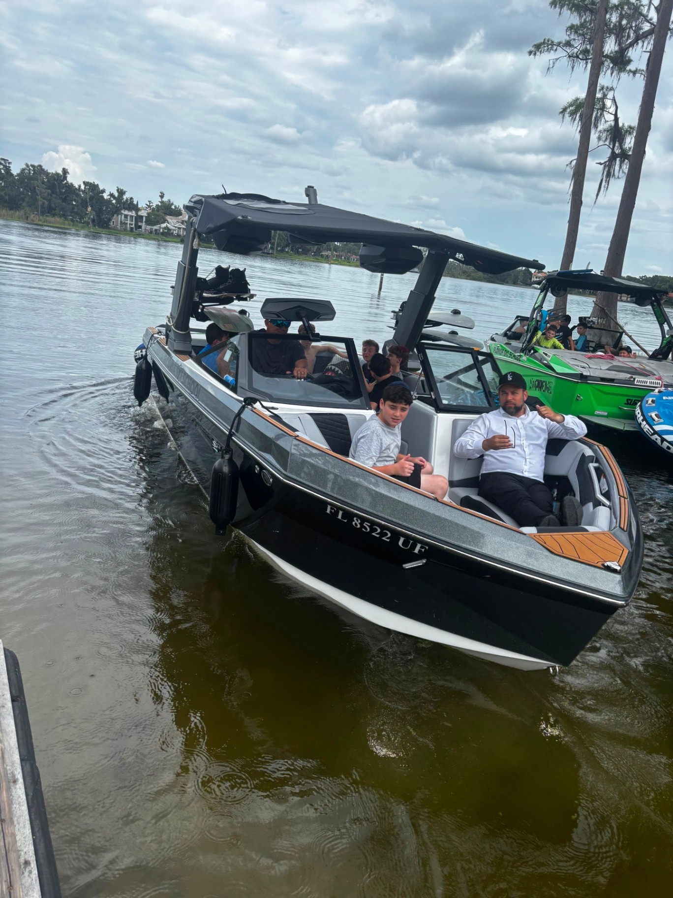 Campers and staff riding a motorboat across a lake