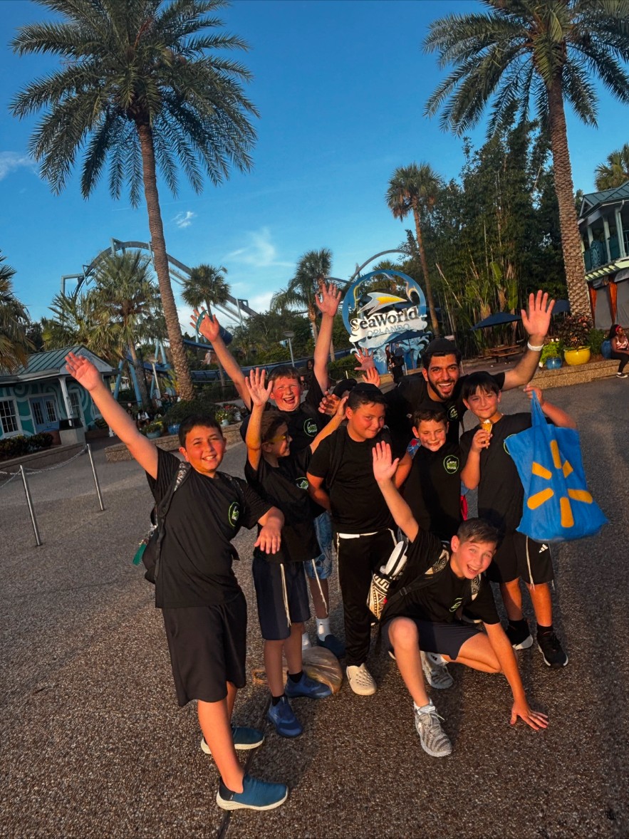 Campers and a counselor posing outside SeaWorld Orlando